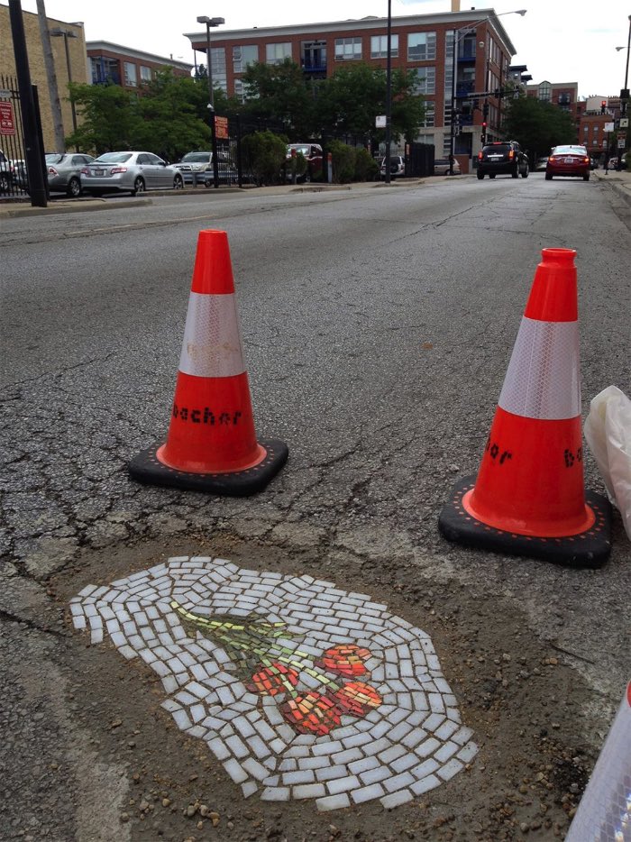 Você não deve ter pensado nisso mas Chicago parece sofrer com um problema de buracos pelas ruas da mesma forma que algumas cidades no Brasil. É, esse problema não é localizado no seu bairro e, pelo menos, algumas pessoas tomam uma iniciativa diferente em outros lugares. Ainda bem. Foi assim que Jim Bachor começou a sua crítica a falta de infra estrutura da cidade de Chicago ao começar a cobrir os buracos da cidade com mosaicos. Sim, mosaicos de azulejos formando pequenos desenhos e cobrindo buracos nas ruas da cidade. Por que ninguém pensou em fazer isso antes? 