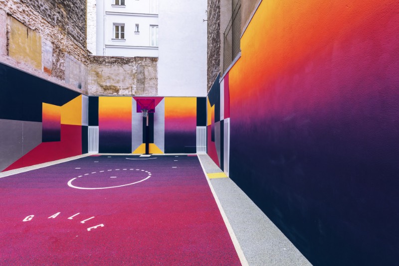 Perdida entre edifícios em Paris, você pode encontrar uma quadra de basquete que é conhecida como Pigalle Basketball Court ou algo similar mas em francês. Lá, o basquete se mistura com a arte e é tudo responsabilidade de Stéphane Ashpool que se juntou a Pigalle, a agência Ill-Studio e ao pessoal da Nike e criaram o visual ultra colorido.